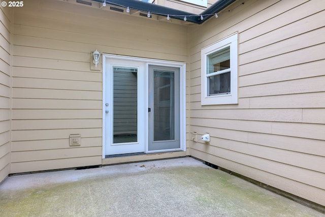 doorway to property featuring a patio area