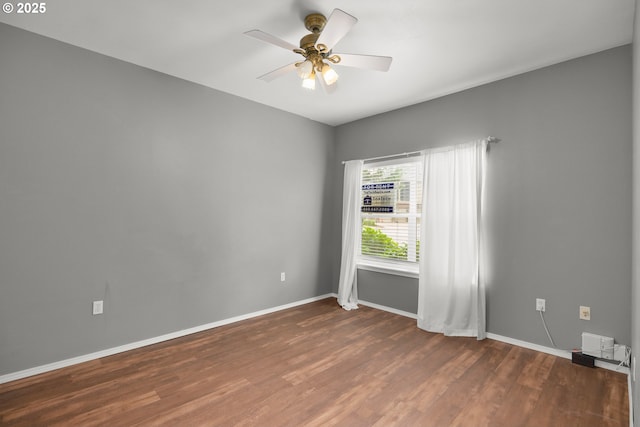 empty room with wood finished floors, baseboards, and ceiling fan