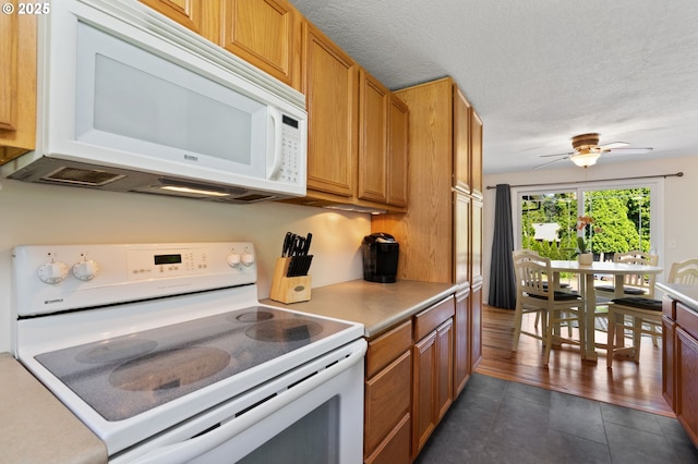 18344 Terry Ave, Lake Oswego, OR 97035 - kitchen with white appliances, a ceiling fan, brown cabinetry, light countertops, and a textured ceiling