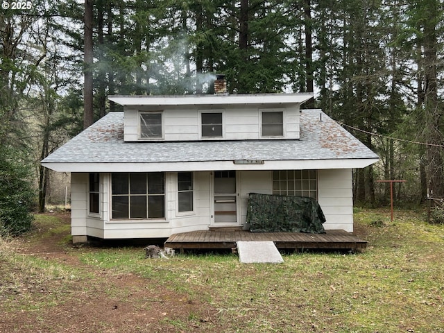 bungalow featuring a chimney and roof with shingles