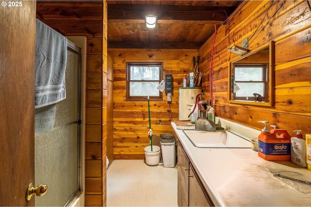 full bathroom featuring a shower with shower door, wooden walls, wooden ceiling, and vanity