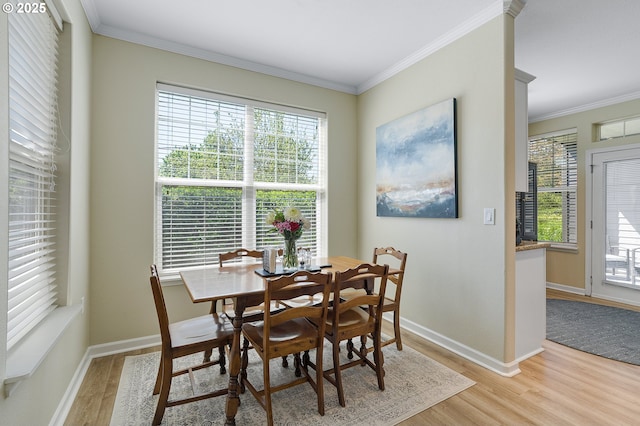595 Springtree Ln, West Linn, OR 97068 - dining space featuring light wood finished floors, crown molding, healthy amount of natural light, and baseboards