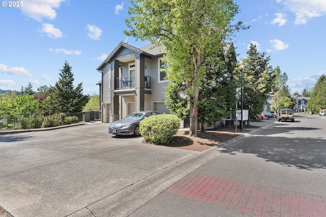 595 Springtree Ln, West Linn, OR 97068 - view of front facade featuring concrete driveway, a balcony, and an attached garage