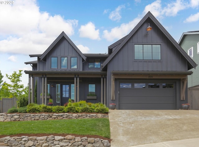 2104 Deerhill Ln, West Linn, OR 97068 - view of front of property featuring board and batten siding, an attached garage, and driveway