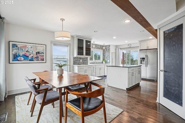 dining space featuring baseboards, beamed ceiling, dark wood finished floors, and recessed lighting