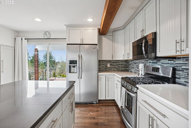 kitchen with stainless steel appliances, dark wood-style flooring, beamed ceiling, and decorative backsplash