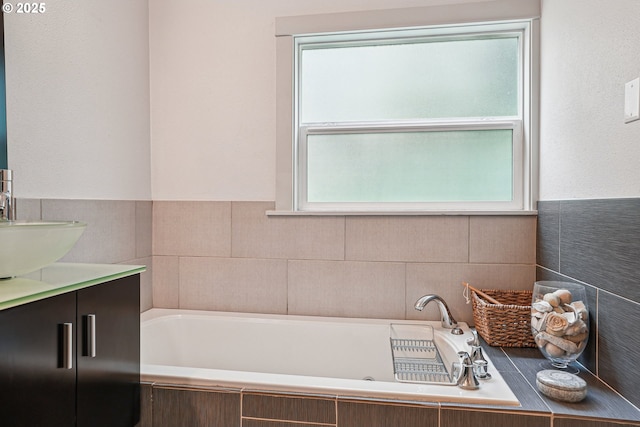 bathroom featuring vanity and a bath