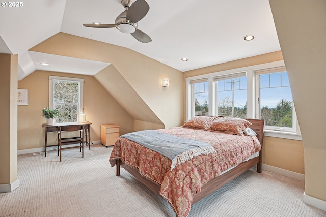 carpeted bedroom with lofted ceiling, multiple windows, and baseboards