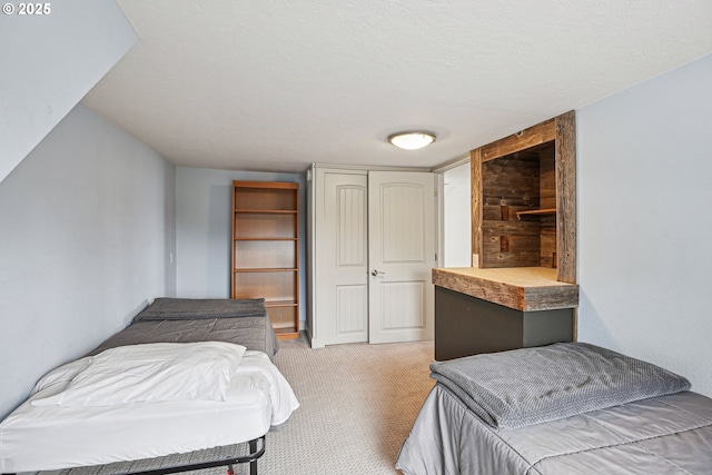 carpeted bedroom featuring a closet and a textured ceiling