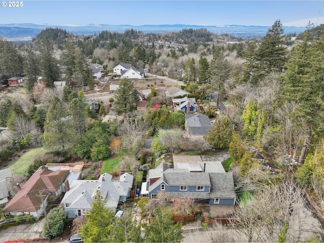 drone / aerial view with a mountain view, a forest view, and a residential view