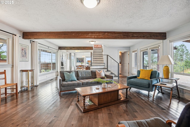 living area with plenty of natural light, wood-type flooring, beamed ceiling, and stairs