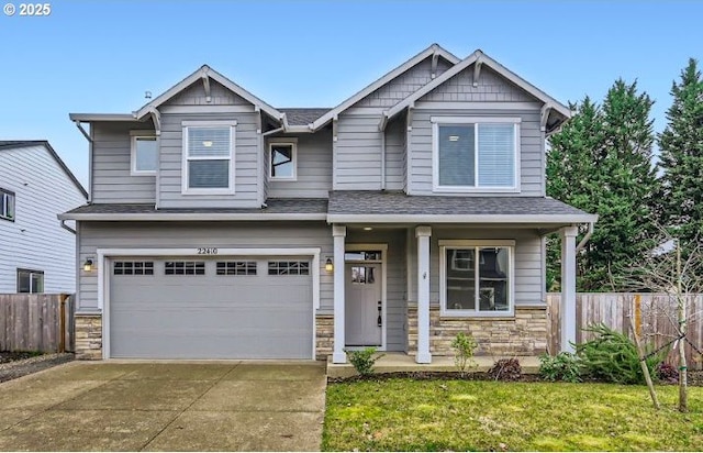 craftsman inspired home with a garage, covered porch, and a front yard