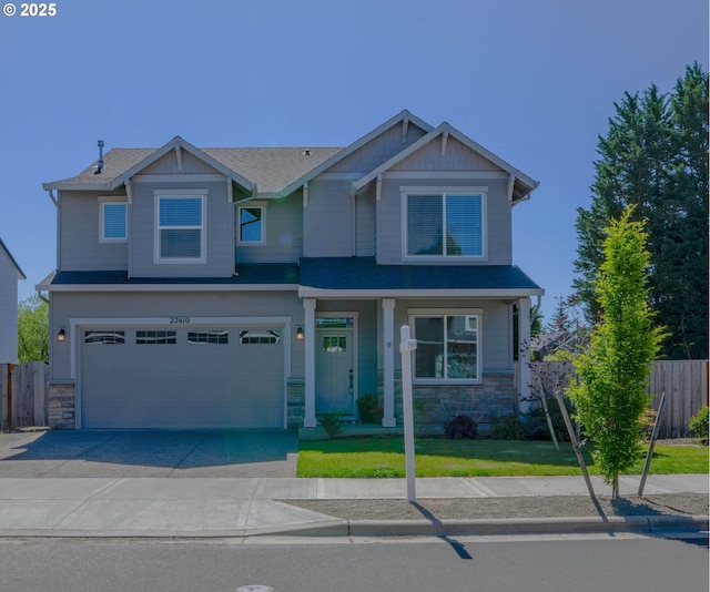 22410 SW Forest Creek Way, Sherwood, OR 97140 - craftsman house featuring stone siding, driveway, and a garage
