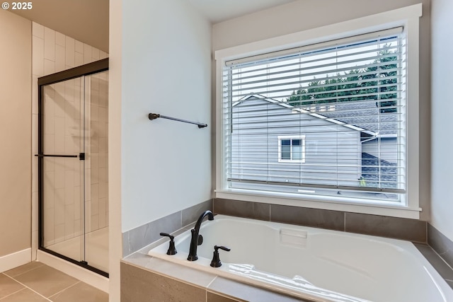 bathroom featuring tile patterned floors and shower with separate bathtub