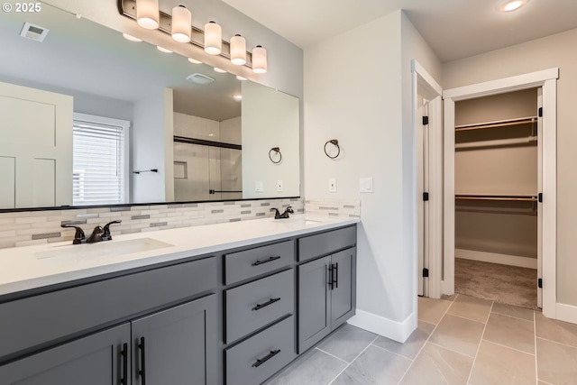 22410 SW Forest Creek Way, Sherwood, OR 97140 - bathroom with decorative backsplash, a stall shower, a walk in closet, and double vanity