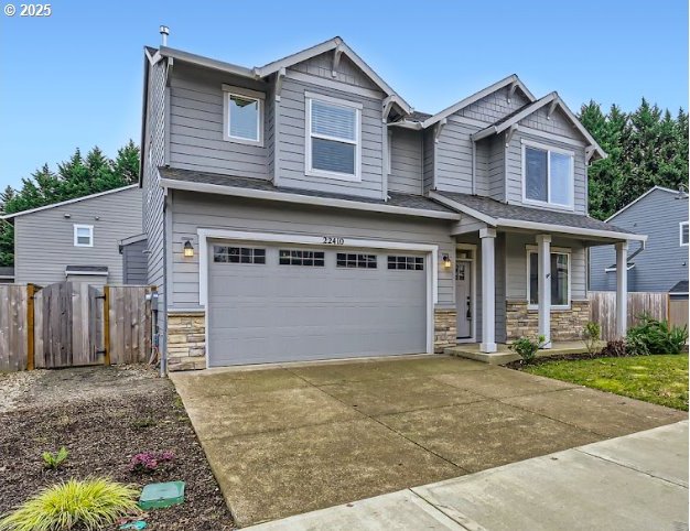 craftsman inspired home featuring a garage and a porch