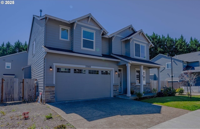 22410 SW Forest Creek Way, Sherwood, OR 97140 - craftsman-style home featuring stone siding, a garage, driveway, and covered porch