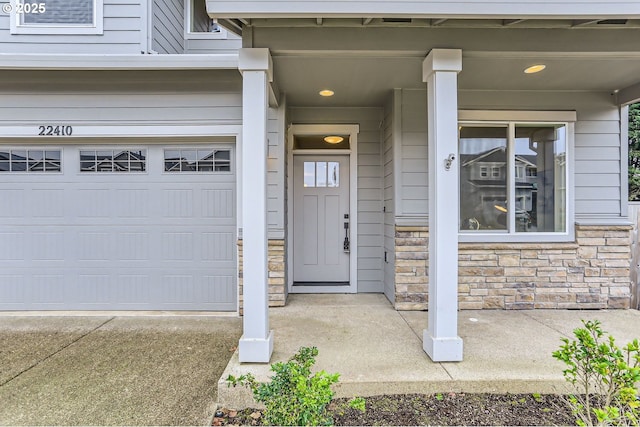 doorway to property with a garage