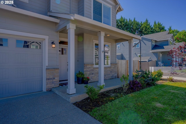 22410 SW Forest Creek Way, Sherwood, OR 97140 - doorway to property featuring covered porch, stone siding, and a garage
