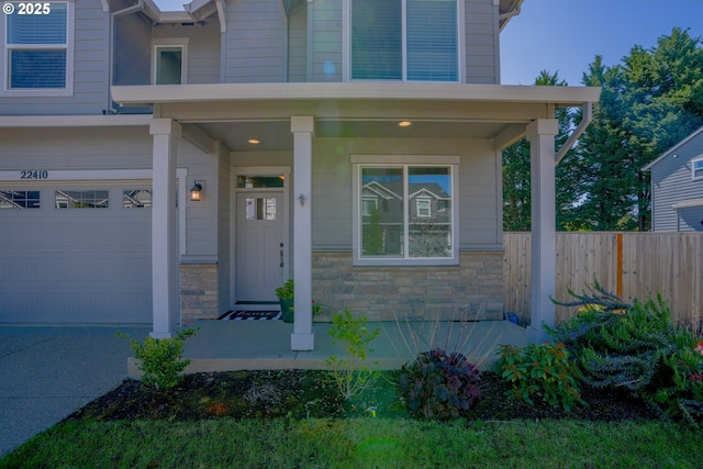 22410 SW Forest Creek Way, Sherwood, OR 97140 - property entrance featuring a garage, stone siding, and a porch