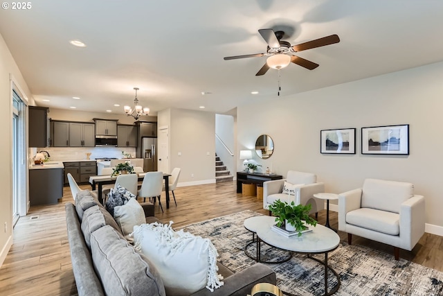 22410 SW Forest Creek Way, Sherwood, OR 97140 - living room featuring stairway, baseboards, a chandelier, a ceiling fan, and recessed lighting