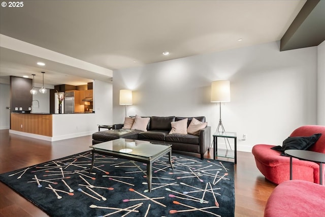 living room featuring sink and hardwood / wood-style floors