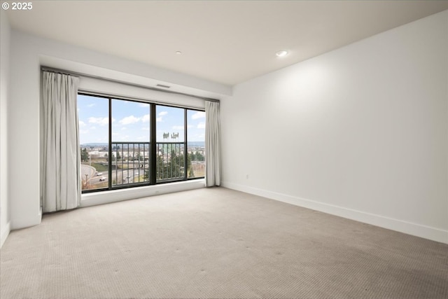 spare room featuring light colored carpet