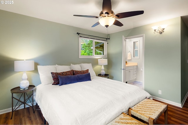 bedroom with baseboards, wood finished floors, connected bathroom, and ceiling fan