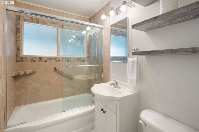 full bathroom with toilet, shower / bath combination with glass door, and vanity
