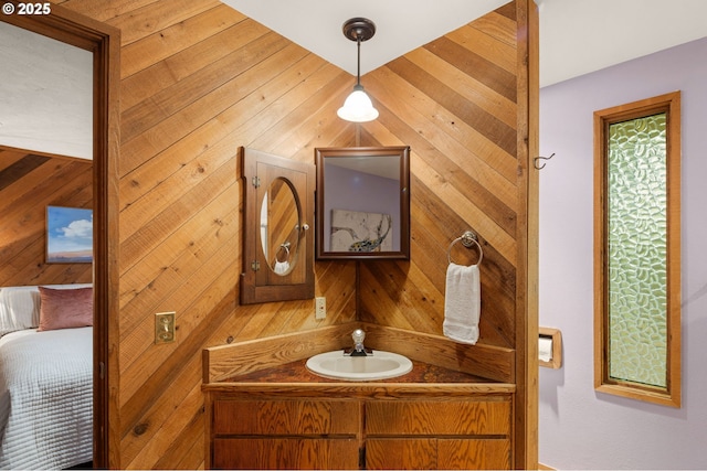bathroom with vanity and wooden walls