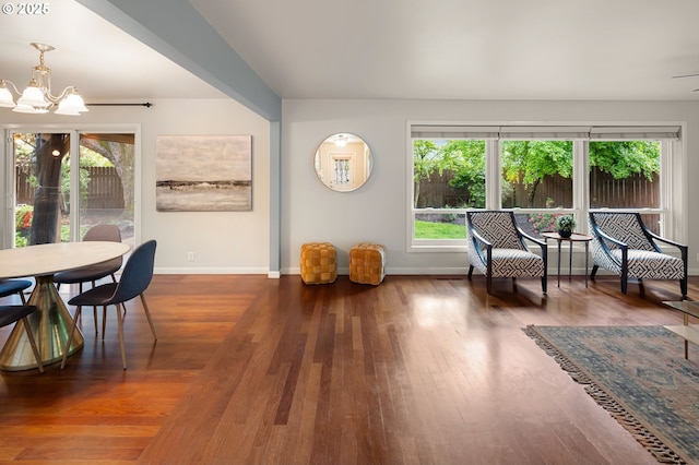 sitting room with a chandelier, plenty of natural light, and baseboards
