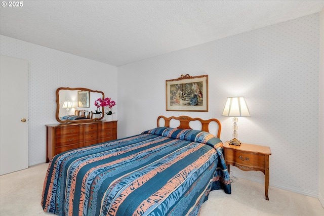 bedroom featuring wallpapered walls, baseboards, carpet floors, and a textured ceiling