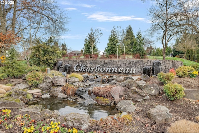 community sign featuring a garden pond