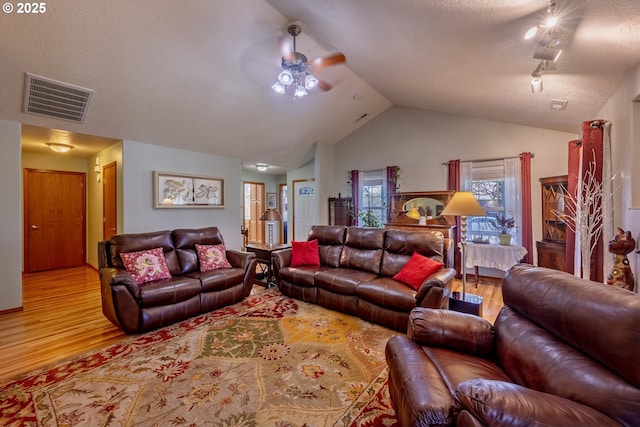 788 SE Meadows Loop, Sheridan, OR 97378 - living room featuring vaulted ceiling, wood finished floors, visible vents, and ceiling fan