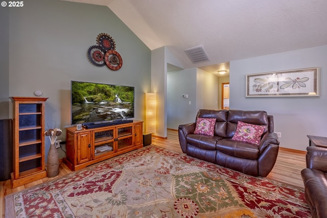 788 SE Meadows Loop, Sheridan, OR 97378 - living room featuring lofted ceiling, light wood-style flooring, and visible vents