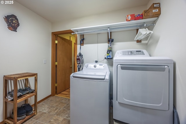 788 SE Meadows Loop, Sheridan, OR 97378 - washroom with baseboards, stone finish flooring, laundry area, and washer and clothes dryer