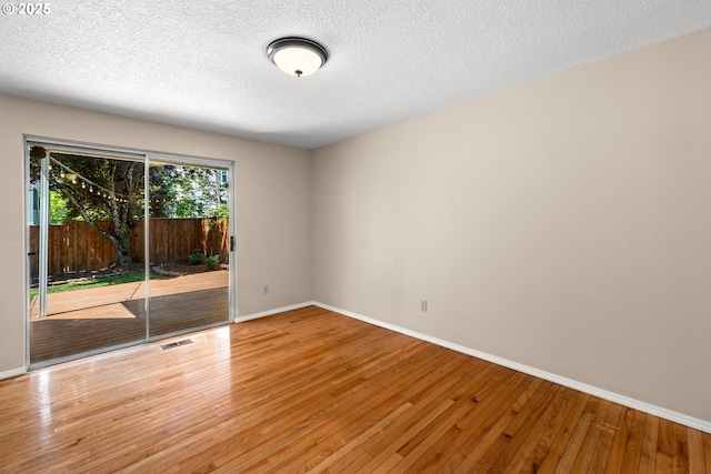 5877 NW 181st Ave, Portland, OR 97229 - empty room featuring hardwood / wood-style floors and a textured ceiling
