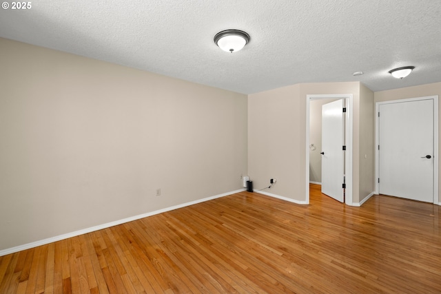 5877 NW 181st Ave, Portland, OR 97229 - unfurnished room with light wood finished floors and a textured ceiling