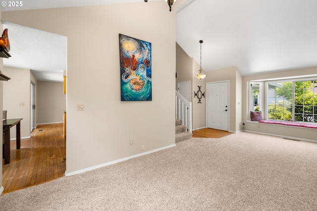 5877 NW 181st Ave, Portland, OR 97229 - entryway featuring lofted ceiling, carpet floors, stairs, and wood finished floors
