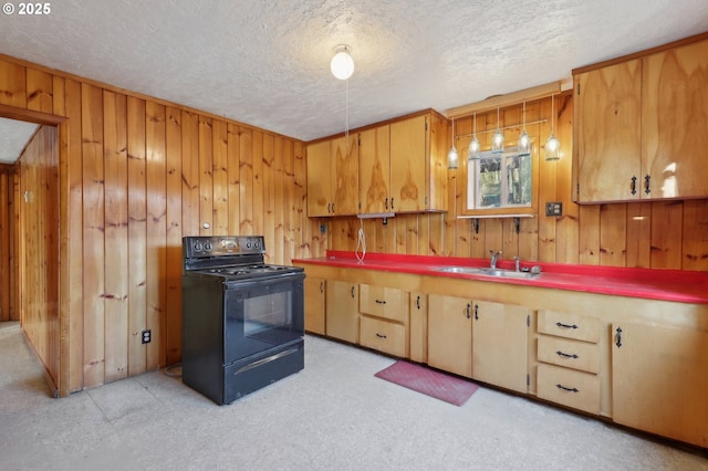 kitchen featuring black / electric stove, wooden walls, sink, and a textured ceiling