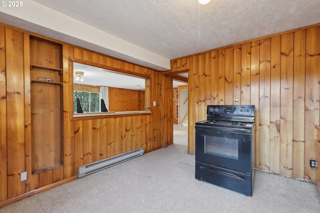 kitchen with baseboard heating, wooden walls, a textured ceiling, and electric range