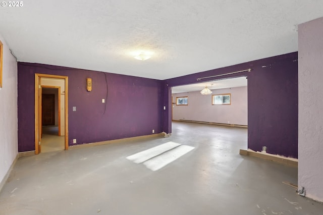 unfurnished room featuring concrete flooring and a textured ceiling