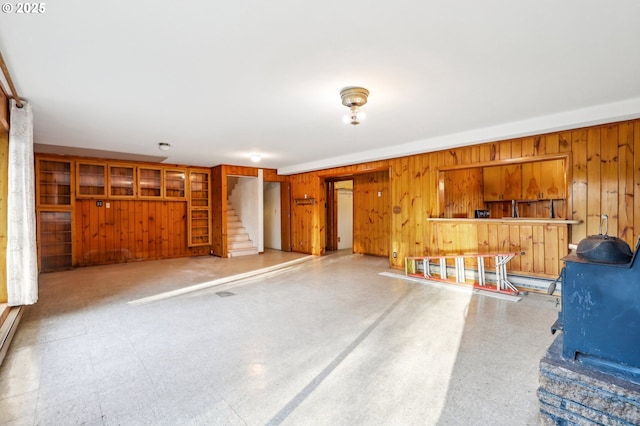 interior space featuring wooden walls and a wood stove