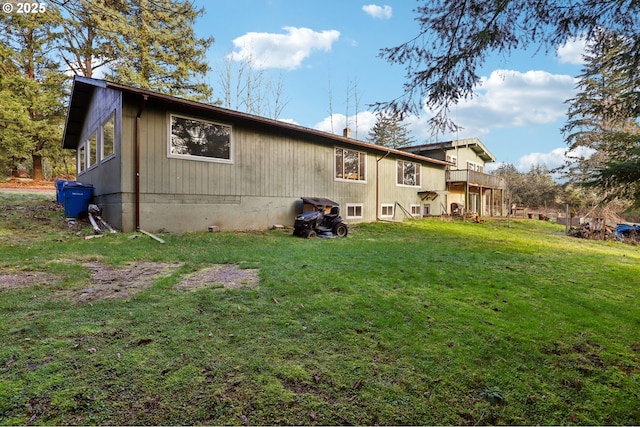 rear view of property with a yard