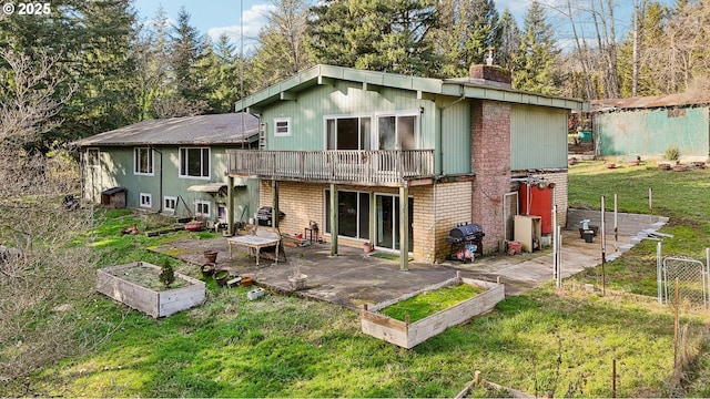 back of property with a patio, a yard, and a deck