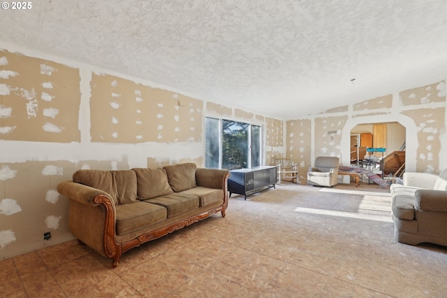 living room featuring lofted ceiling and a textured ceiling