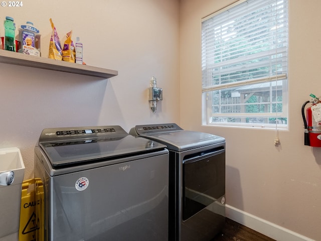 laundry room featuring dark hardwood / wood-style flooring and washing machine and clothes dryer