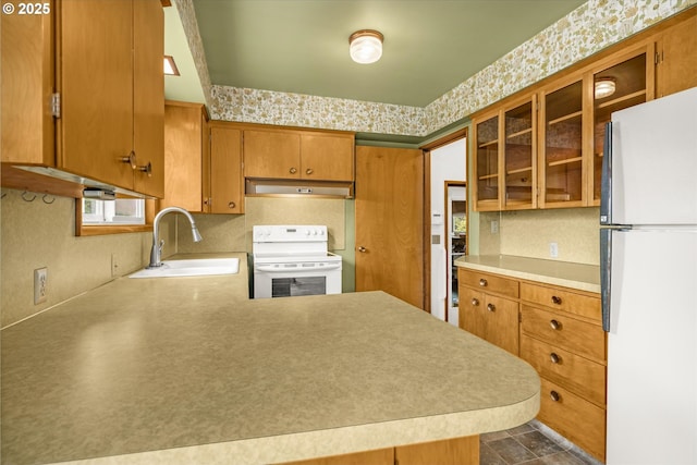 1220 NE 196th Ave, Portland, OR 97230 - kitchen featuring white appliances, under cabinet range hood, brown cabinets, light countertops, and glass insert cabinets