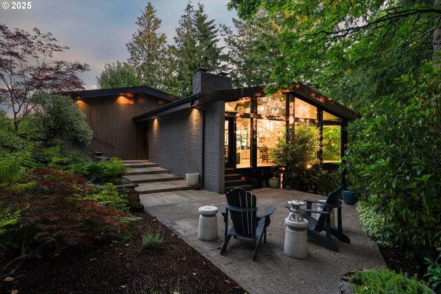 1801 NW Walmer Dr, Portland, OR 97229 - back of house with a patio area, a chimney, and brick siding