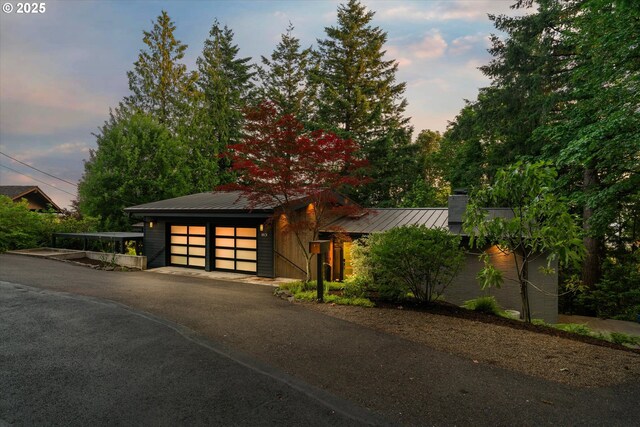 1801 NW Walmer Dr, Portland, OR 97229 - view of front facade with a metal roof, asphalt driveway, and a chimney